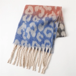 Detail of gradient leopard print scarf with soft fringe edges in red and blue