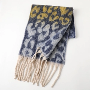 Close-up of leopard print cashmere feel shawl with navy blue texture and fringe detail