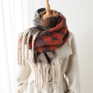 Detailed view of the thick fringe scarf featuring vintage floral patterns and soft tassels