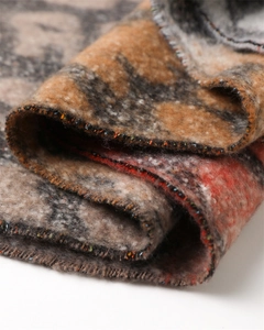 Close-up detail of soft cashmere-like fabric texture on stylish leopard print scarf