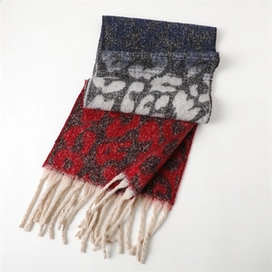 Detail of thick leopard print scarf with red and blue blocks and off-white fringes