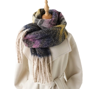Colorful chevron striped cashmere feel scarf with fringe on a beige coat model