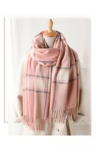 Detailed view of soft plaid scarf featuring pink and grey checks with delicate fringe trim