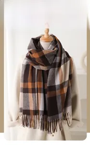 Detail of plaid winter scarf with tassel fringe and soft faux cashmere texture