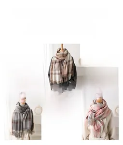 Detail view of winter plaid scarves with fringes in brown, beige, and pink check patterns
