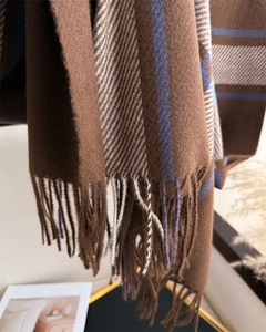 Close-up of soft plaid scarf fabric with fringe edge and large check pattern