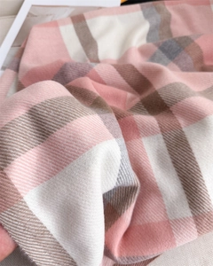 Close-up of pink and brown plaid scarf featuring soft twill weave and brushed texture