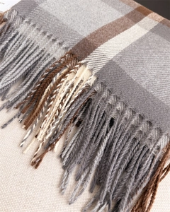 Detail shot of the soft plaid scarf with classic tassels and high-quality twill weave