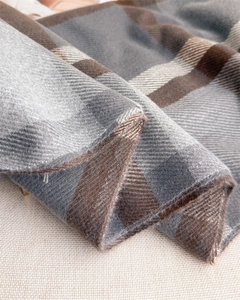 Close-up of classic grey and brown plaid scarf showing soft twill weave texture