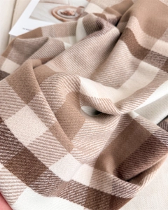 Detailed close-up of soft cashmere-feel plaid scarf with classic twill weave texture