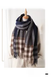 Detailed view of the thick plaid scarf featuring classic tassels and warm autumn tones