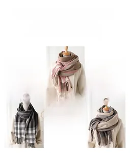 Detail of plaid patterned scarves with tassels in pink, grey and beige color options