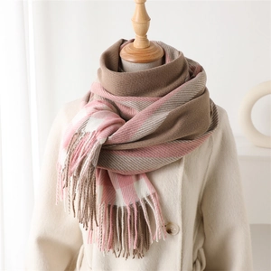 Detail of pink and brown plaid cashmere scarf with long tassels on a beige wool coat