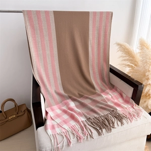 Detailed close-up of pink and beige plaid cashmere-feel scarf with elegant tassels