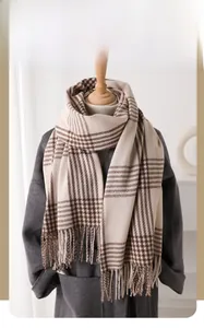 Detail of vintage plaid cashmere-like scarf showing texture and tassel craftsmanship