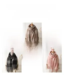 Close-up of classic plaid tassels on cashmere-like scarves in brown, white, and pink