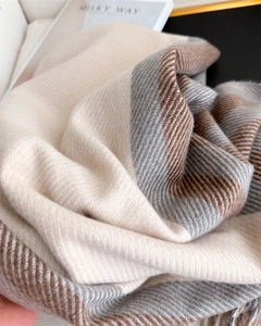 Detailed view of thick herringbone weave scarf with fringe tassels in beige and coffee