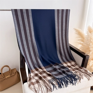 Detail of multi-color plaid cashmere shawl showing elegant fringe and knit texture