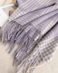Detail of lavender plaid knit scarf showing soft texture and delicate tassel fringe