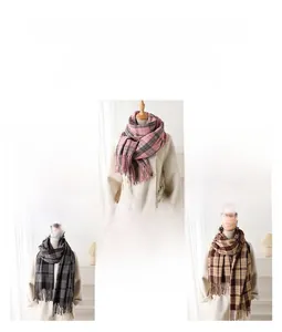 Detail of plaid cashmere-like scarf with fringe showing pink, grey, and tan color options