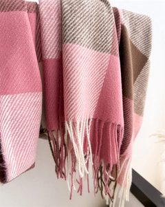 Vue détaillée d'une écharpe à carreaux rose et marron avec tissage sergé et longs franges