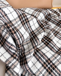 Close-up of warm faux cashmere scarf with classic plaid pattern and soft twill texture