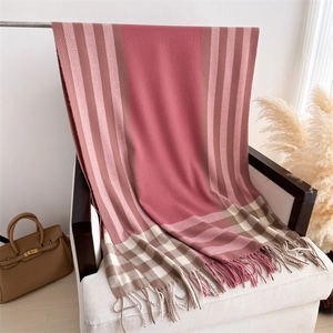 Detail of soft cashmere feel scarf with pink and beige check pattern and tassel fringe