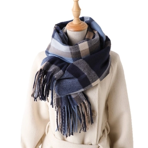 Classic plaid imitation cashmere scarf with tassels styled on a white winter coat