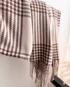 Detailed view of checkered wool scarf with coffee brown patterns and fringe tassels
