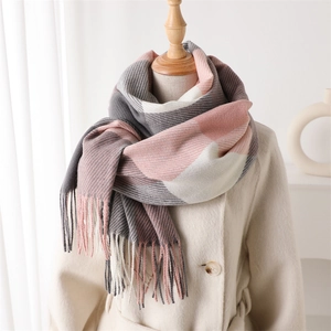 Détail de l'écharpe à carreaux rose et gris avec franges sur un manteau