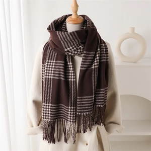 Classic dark brown and beige plaid cashmere-like scarf with fringe on a beige wool coat
