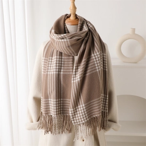 Classic earth-tone plaid scarf with long tassels draped on a beige coat for autumn winter