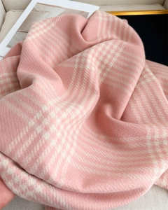 Detail of pink and cream plaid scarf showing soft faux cashmere weave and fringe