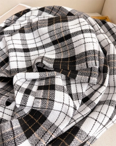 Detailed herringbone texture and plaid pattern on thick cashmere-like winter scarf
