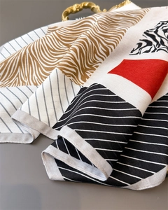 Detail of herringbone cotton linen scarf featuring tiger, zebra, and geometric prints