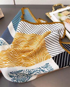 Detailed view of color-block scarf with geometric patterns and herring-bone texture