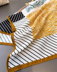 Detailed view of geometric herringbone silk scarf with animal print and blue patterns