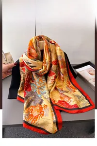 Detail of silk scarf with classical oriental print draped over a black outfit