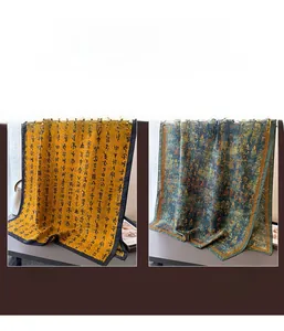 Close-up of ink calligraphy pattern on orange and green silk scarves for women