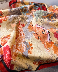 Detail of silk scarf showing Chinese art print with golden pine and red temple motifs