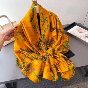 Elegant bright yellow silk scarf with floral plum blossom print and smooth satin texture