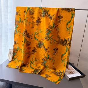 Elegant orange silk scarf with bamboo floral prints for sun protection and travel wear