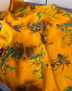 Detail of orange silk scarf with traditional Chinese landscape print and calligraphy