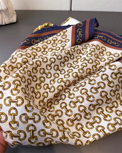 Detailed macro view of the chain pattern and twill weave texture on this vintage silk scarf