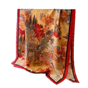 Elegant silk scarf with landscape print and red border shown in a flowing drape