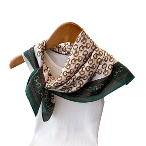 Vintage chain and horsebit pattern silk scarf in dark green and beige on a hanger