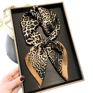 Classic leopard print silk square scarf elegantly presented on a luxury metal tray