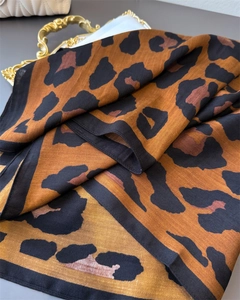 Detailed view of leopard print cotton-linen shawl with twill texture on vintage tray