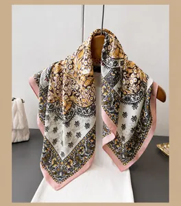 Detail of floral patterned cotton-linen scarf hanging elegantly on a wooden hanger