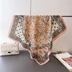 Detail view of cotton-linen square scarf with paisley floral print and elegant pink border